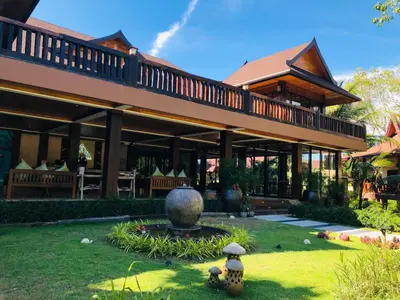 a large building with a fountain in the yard at Phi Phi Villa Resort in Phi Phi Don