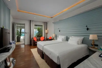 a bedroom with a large bed and a couch at The Boathouse Phuket-SHA Plus in Kata Beach
