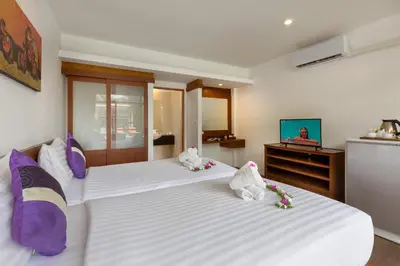 two stuffed animals sitting on a bed in a room at Phuket Sea Resort SHA Extra Plus in Rawai Beach