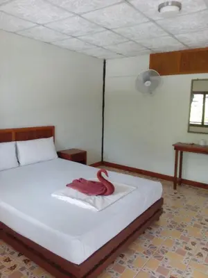 a bedroom with a bed with a red towel on it at Scenery Guest House in Phi Phi Don