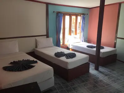a room with two beds and a window at Scenery Guest House in Phi Phi Don