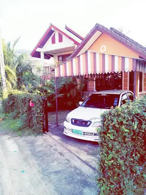 a white car parked in front of a house at The Endless Bangtao Residence VC 2 in Bang Tao Beach