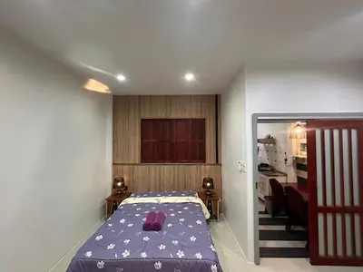 a small bedroom with a bed and a living room at The Endless Bangtao Residence CAC 3 in Bang Tao Beach