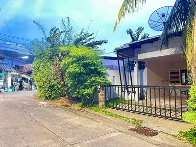a street with a fence next to a building at The Endless Bangtao Residence CAC 3 in Bang Tao Beach
