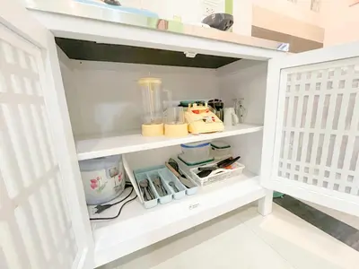 a kitchen pantry with white shelves and utensils at The Endless Bangtao Residence CAC 3 in Bang Tao Beach