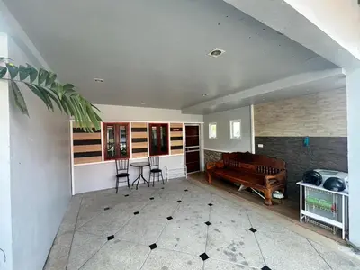 a living room with a couch and a table and chairs at The Endless Bangtao Residence CAC 3 in Bang Tao Beach
