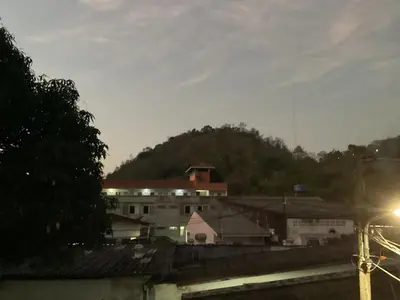 a group of buildings with a mountain in the background at mom's home in Phuket Town