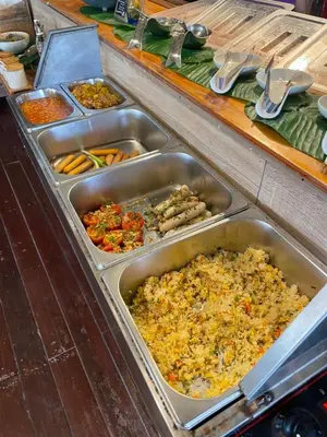 a buffet with sinks full of different types of food at Mama Beach Residence - Adults Only in Phi Phi Don