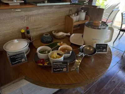 a table with a plate of food on it at Mama Beach Residence - Adults Only in Phi Phi Don