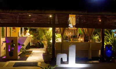 a restaurant with the word cafe in front of it at night at Mama Beach Residence - Adults Only in Phi Phi Don