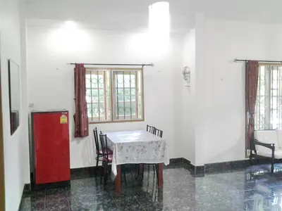 a room with a table and a red refrigerator at The Endless Bangtao Residence Chat 1 in Bang Tao Beach
