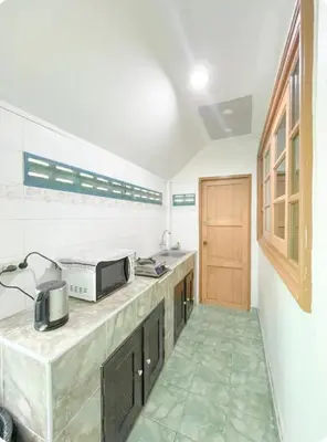 a kitchen with a counter with a microwave on it at The Endless Bangtao Residence Chat 1 in Bang Tao Beach