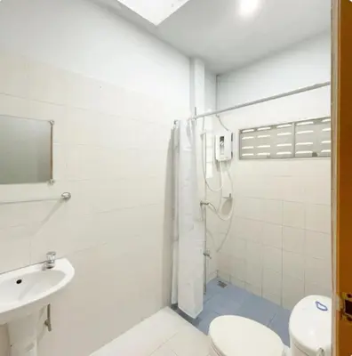 a bathroom with a shower and a toilet and a sink at The Endless Bangtao Residence Chat 1 in Bang Tao Beach