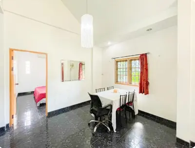 a dining room with a table and a bedroom at The Endless Bangtao Residence Chat 1 in Bang Tao Beach