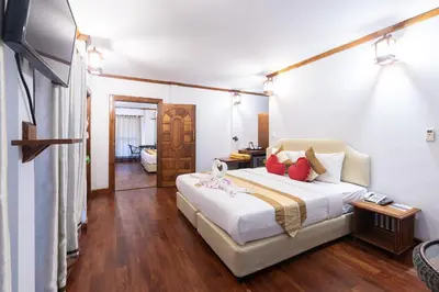 a bedroom with a large white bed with red pillows at Phi Phi The Beach Resort in Phi Phi Don