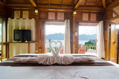a bed with a white swan in the middle at Phi Phi The Beach Resort in Phi Phi Don