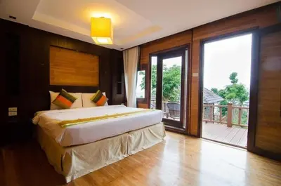 a bedroom with a large bed and a balcony at Phi Phi The Beach Resort in Phi Phi Don
