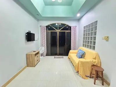 a living room with a bed and a tv and a chair at The Endless Bangtao Residence Wat 1 in Bang Tao Beach