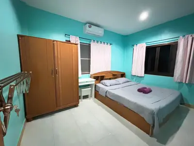 a small bedroom with a bed and a desk at The Endless Bangtao Residence Wat 1 in Bang Tao Beach