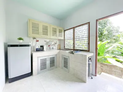 a kitchen with a sink and a refrigerator at The Endless Bangtao Residence Wat 1 in Bang Tao Beach