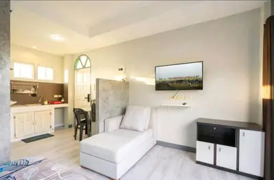 a living room with a white couch and a kitchen at The Endless Bangtao Apartment AC1234 in Bang Tao Beach