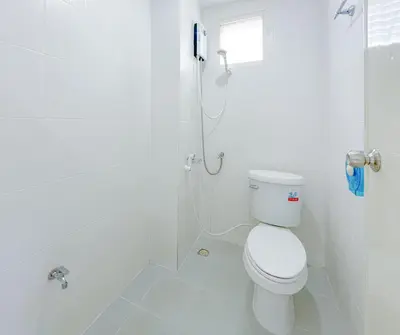 a white bathroom with a toilet and a shower at The Endless Bangtao Apartment AC1234 in Bang Tao Beach