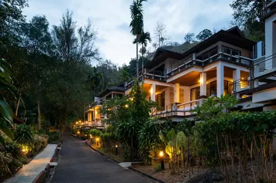 a house with lights on the side of a street at Baan Krating Phuket Resort Naiharn-SHA Plus in Nai Harn Beach