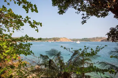 a view of a large body of water with a boat at Baan Krating Phuket Resort Naiharn-SHA Plus in Nai Harn Beach