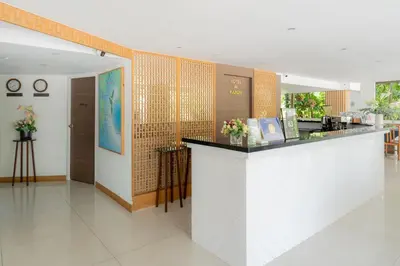 a restaurant with a counter in a room at Hotel De Karon in Karon Beach