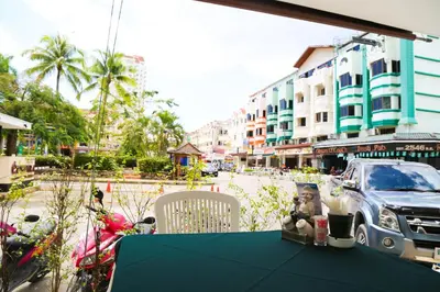 a blue table with a teddy bear sitting on top of a street at Hotel De Karon in Karon Beach