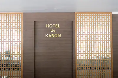 a wooden door with the words hotel do kron at Hotel De Karon in Karon Beach