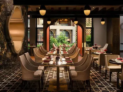 a long dining room with a long table and chairs at Avista Grande Phuket Karon - MGallery in Karon Beach