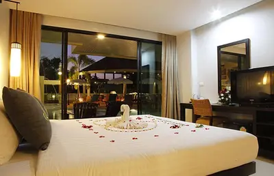a bedroom with a bed with a swan on it at Palmyra Patong Resort Phuket - SHA Extra Plus in Patong Beach