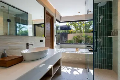 a bathroom with a tub and a sink and a shower at De Malee Pool Villas in Ao Nang Beach