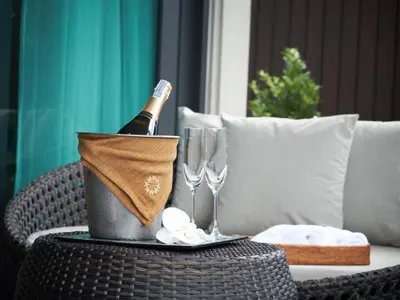 a bottle of champagne in a bucket on a table at De Malee Pool Villas in Ao Nang Beach