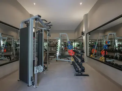 a gym with treadmills and machines in a room at De Malee Pool Villas in Ao Nang Beach