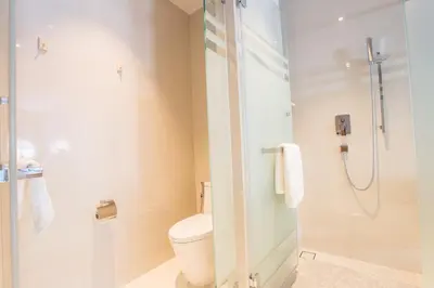 a bathroom with a toilet and a shower at Beyond Patong in Patong Beach