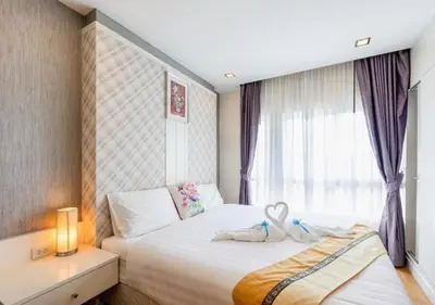 a bedroom with a bed with two stuffed animals on it at Backpacker Street Airport Place in Nai Yang Beach