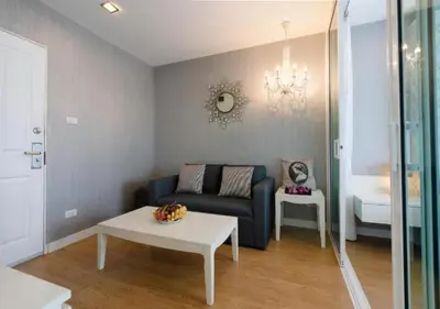 a living room with a couch and a table at Backpacker Street Airport Place in Nai Yang Beach