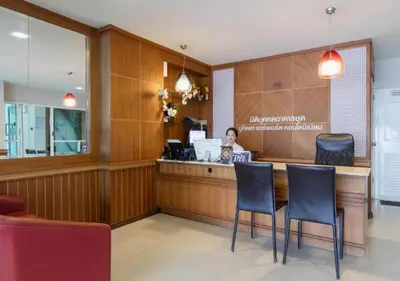 a woman sitting at a counter in a restaurant at Backpacker Street Airport Place in Nai Yang Beach