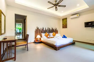 a bedroom with a bed and a table and a desk at Ka villa private pool & maid by Lofty in Rawai Beach