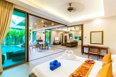 a bedroom with a bed and a living room at Ka villa private pool & maid by Lofty in Rawai Beach