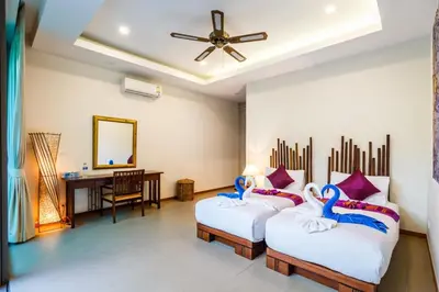 two beds in a room with a desk and a mirror at Ka villa private pool & maid by Lofty in Rawai Beach