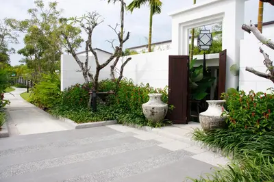 a walkway in front of a house with vases at Two Villas HOLIDAY - Oxygen Style Bangtao Beach, Phuket in Bang Tao Beach
