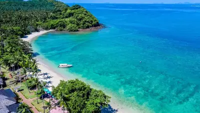 an aerial view of a beach with a boat in the water at Elixir Resort Koh Yao Yai - SHA Plus in Ko Yao Yai