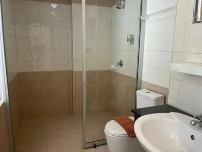 a bathroom with a shower and a toilet and a sink at Thai Siam in Patong Beach