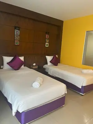 two beds in a hotel room with at Thai Siam in Patong Beach