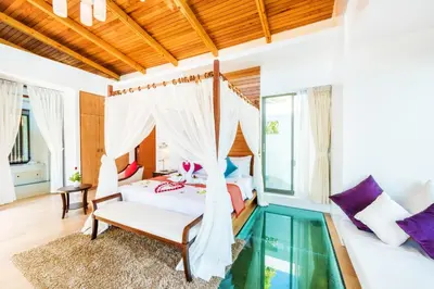 a bedroom with a bed and a glass floor at Wyndham Sea Pearl Resort, Phuket in Patong Beach