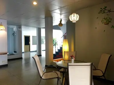 a dining room with a table and chairs at Summer Hotel in Phuket Town