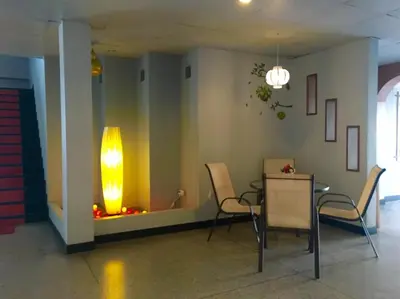 a room with a table and chairs and a light at Summer Hotel in Phuket Town